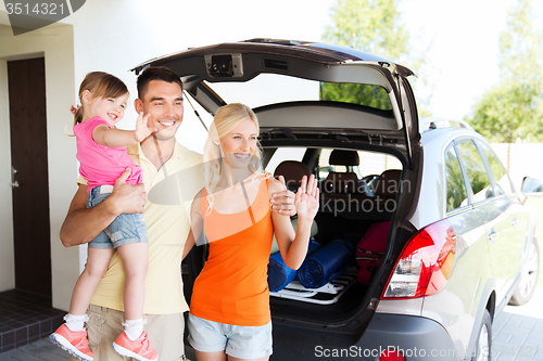 Image of happy family with hatchback car at home parking