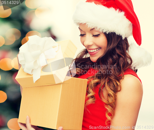 Image of smiling woman in santa helper hat with gift box