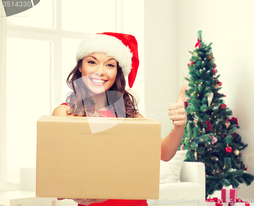Image of smiling woman in santa helper hat with parcel box