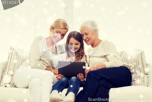 Image of smiling family with tablet pc at home