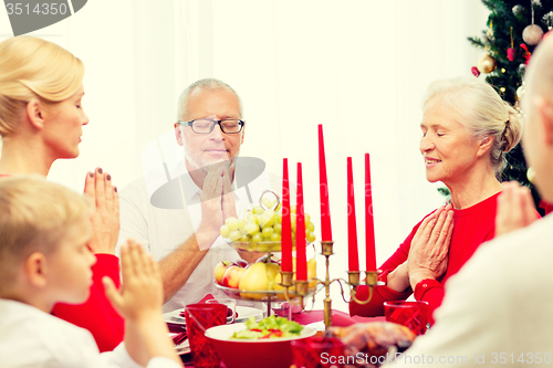 Image of smiling family having holiday dinner at home