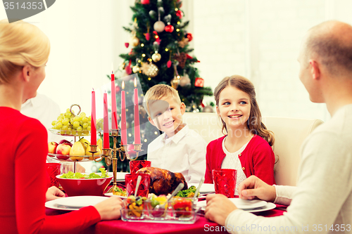 Image of smiling family having holiday dinner at home
