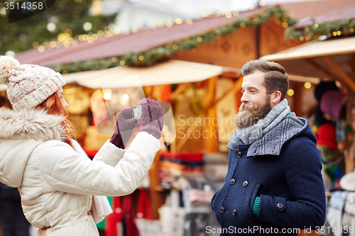 Image of couple taking selfie with smartphone in old town