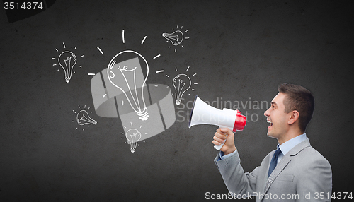 Image of happy businessman in suit speaking to megaphone