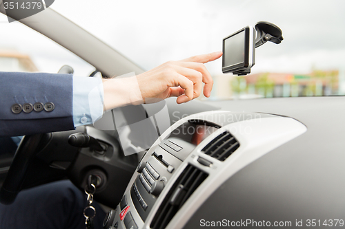 Image of close up of man with gps navigator driving car