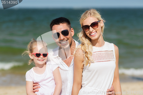 Image of happy family in sunglasses on summer beach