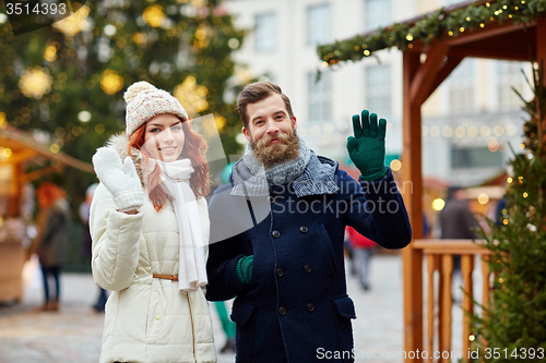 Image of happy couple walking in old town