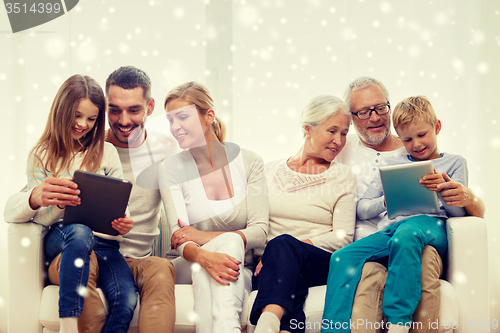 Image of smiling family with tablet pc computers at home