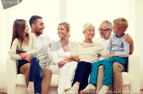 Image of happy family sitting on couch at home