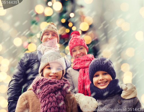 Image of happy family in winter clothes outdoors