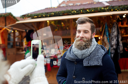Image of couple taking selfie with smartphone in old town