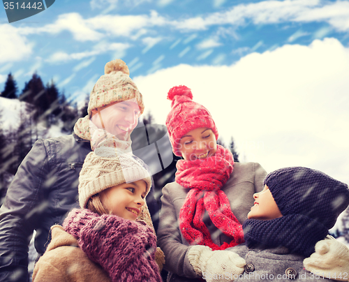 Image of happy family in winter clothes outdoors