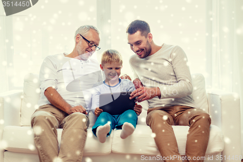 Image of smiling family with tablet pc at home