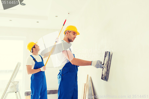 Image of group of builders with tools indoors