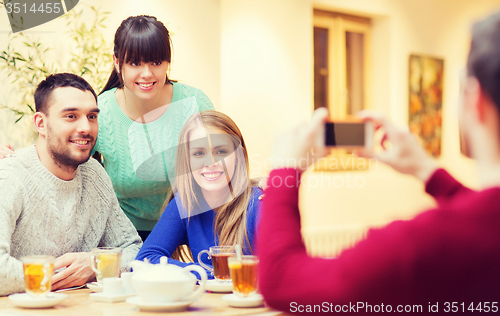 Image of group of friends taking picture with smartphone