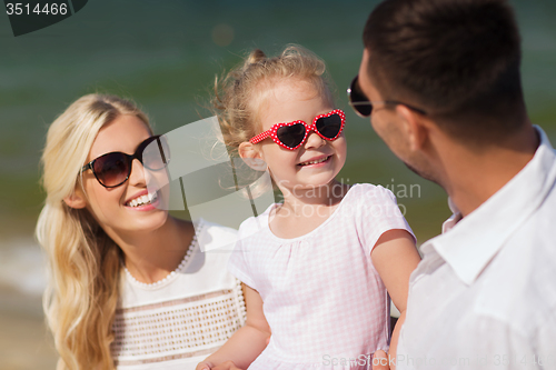 Image of happy family in sunglasses on summer beach