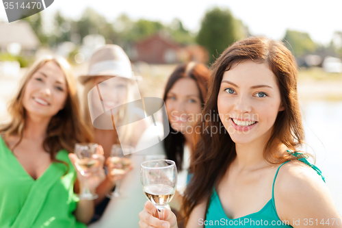 Image of smiling girls with champagne glasses