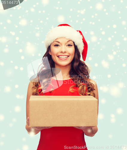 Image of smiling woman in santa helper hat with parcel box