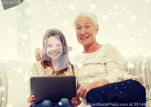 Image of smiling family with tablet pc at home