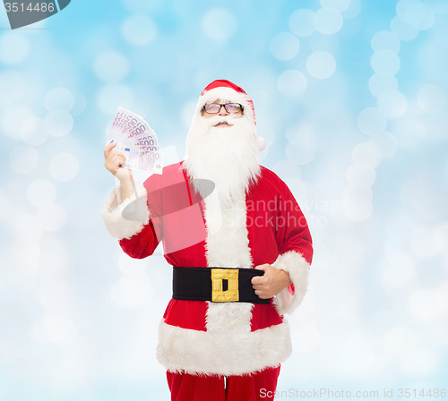 Image of man in costume of santa claus with euro money