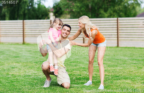 Image of happy family hugging outdoors