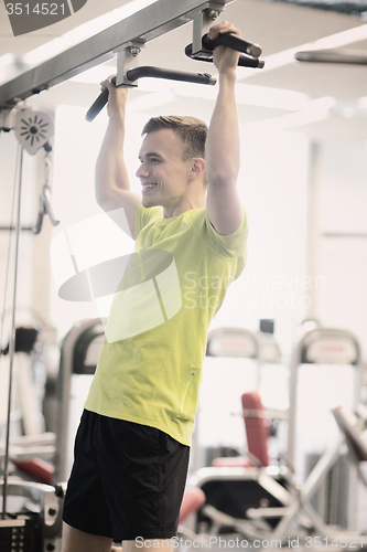 Image of smiling man exercising in gym