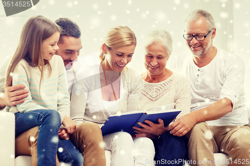 Image of happy family with book or photo album at home