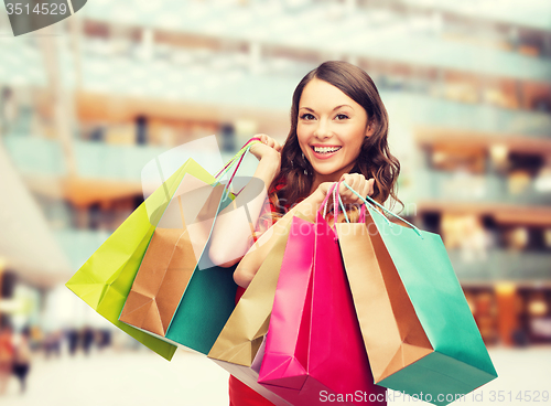 Image of smiling woman with colorful shopping bags