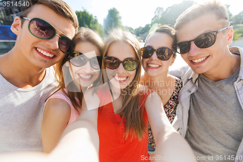 Image of smiling friends taking selfie