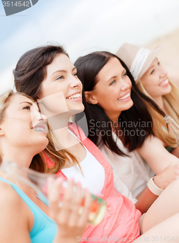 Image of girls with drinks on the beach