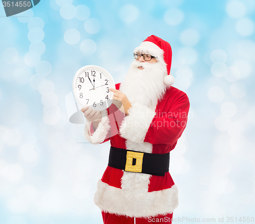 Image of man in costume of santa claus with clock