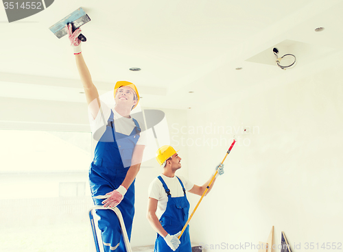 Image of group of builders with tools indoors