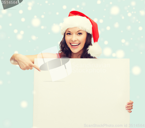 Image of woman in santa helper hat with blank white board