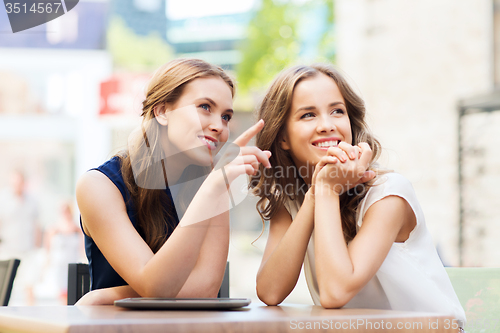 Image of happy young women or teenage girls with tablet pc