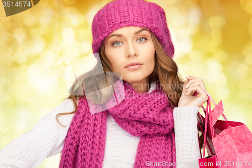 Image of young woman in winter clothes with shopping bags