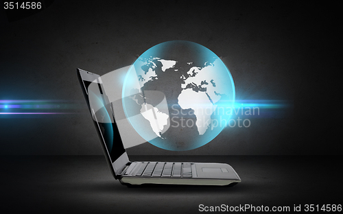 Image of open laptop computer with globe projection