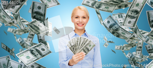 Image of smiling businesswoman with dollar cash money