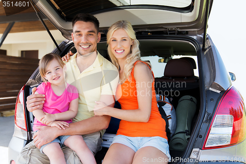 Image of happy family with hatchback car at home parking