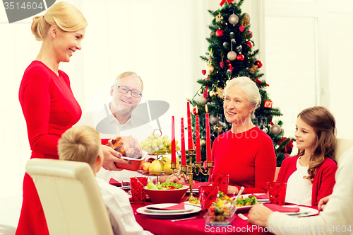 Image of smiling family having holiday dinner at home