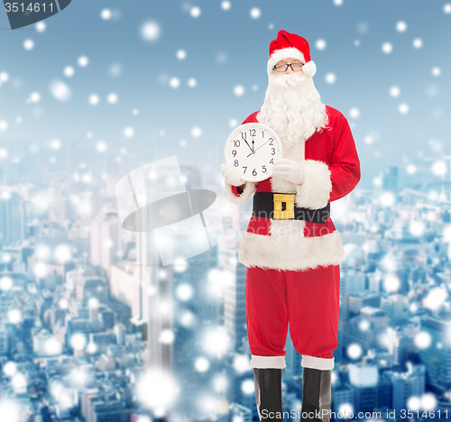 Image of man in costume of santa claus with clock