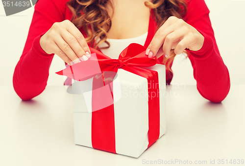 Image of woman hands opening gift boxes