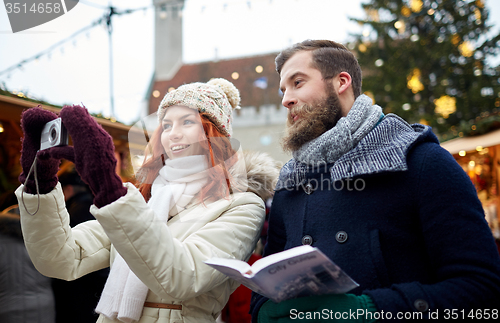 Image of couple taking selfie with smartphone in old town