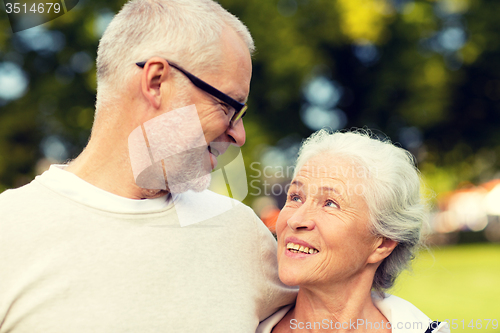 Image of senior couple hugging in city park