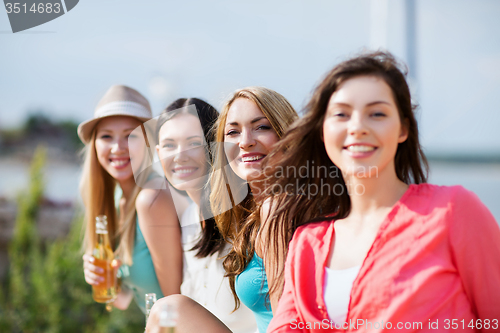 Image of girls with drinks on the beach