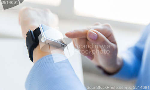 Image of close up of hands setting smart watch