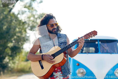 Image of hippie man playing guitar over minivan car outdoor