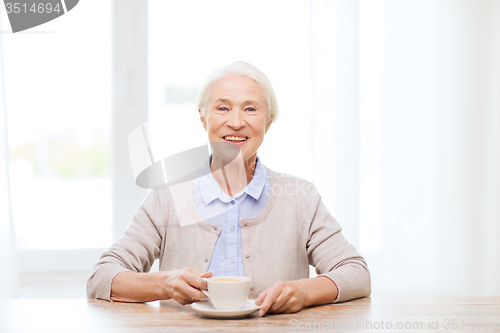 Image of happy senior woman with cup of coffee