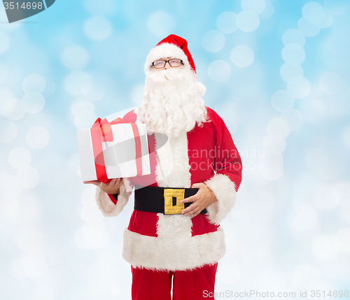 Image of man in costume of santa claus with gift box