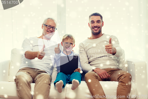 Image of smiling family with tablet pc at home