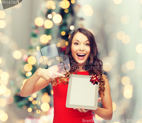 Image of smiling woman in red dress with tablet pc